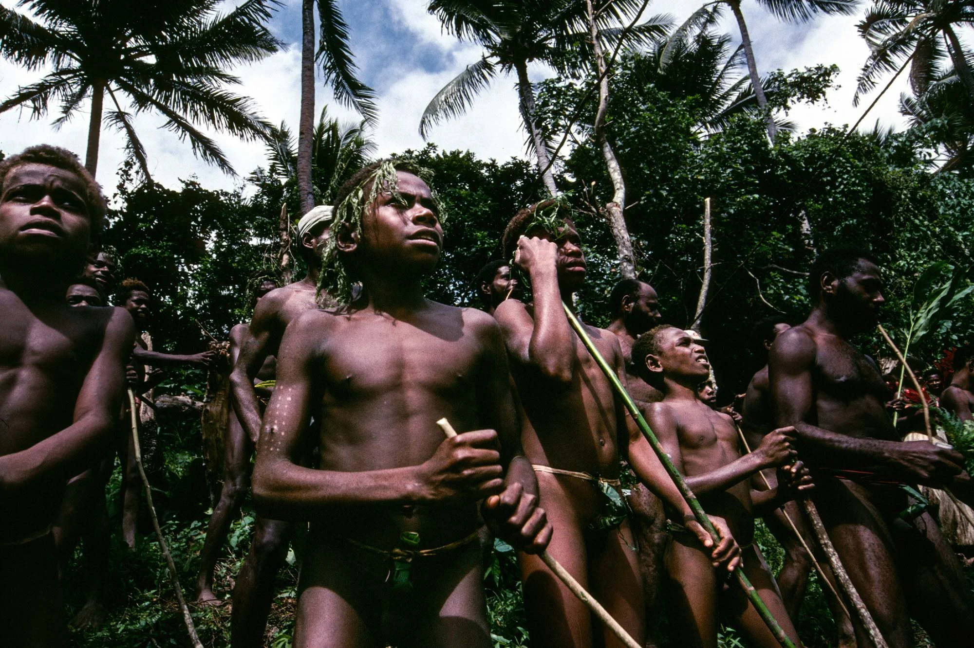 Members of the Small Mamba tribe watch the land dive. Naghol (or land diving) is a significant cultural ritual on Pentecost Island, Vanuatu, performed by men from April to June to ensure a bountiful yam harvest 