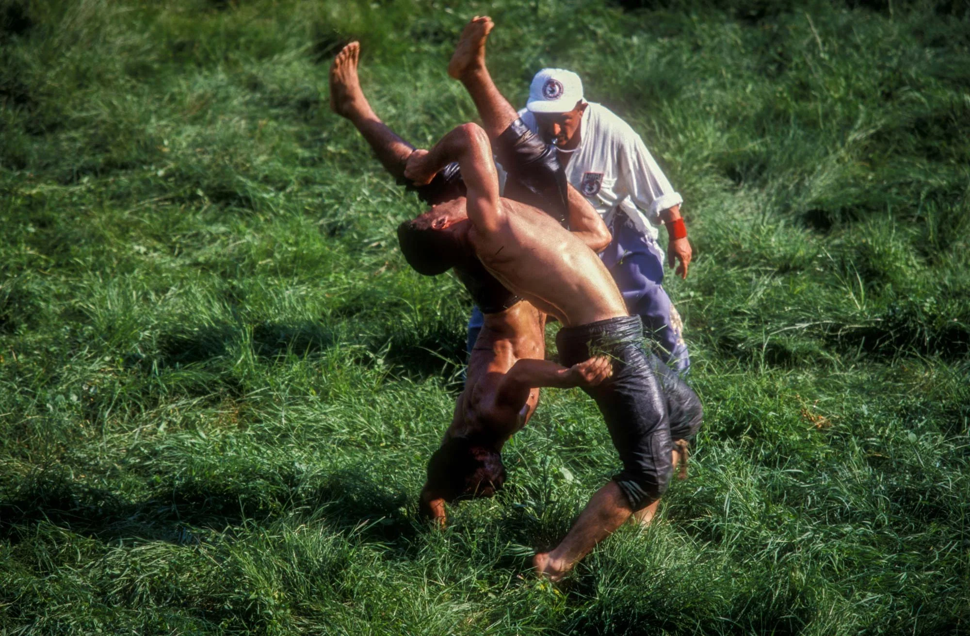 Kirkpinar Olive Oil Wrestling Festival, Edirne, Turkey. The judge looks on as a wrestler is thrown 