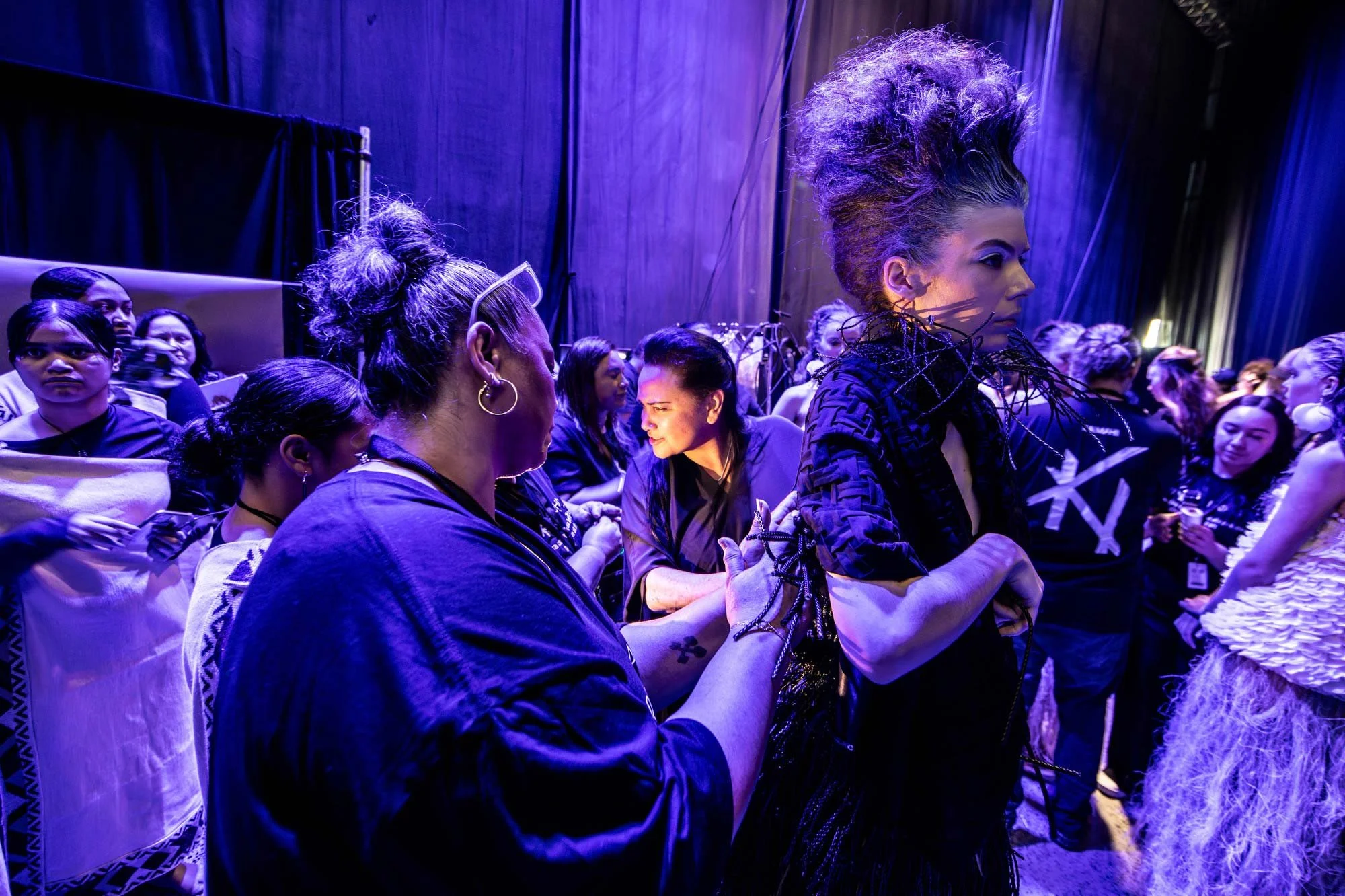 9:56 AM Kiri Nathan and assistants make final adjustments to Hopes outfit. Hope Phillips walks three runways shows on the first day of Kahuria - New Zealand Fashion Week.