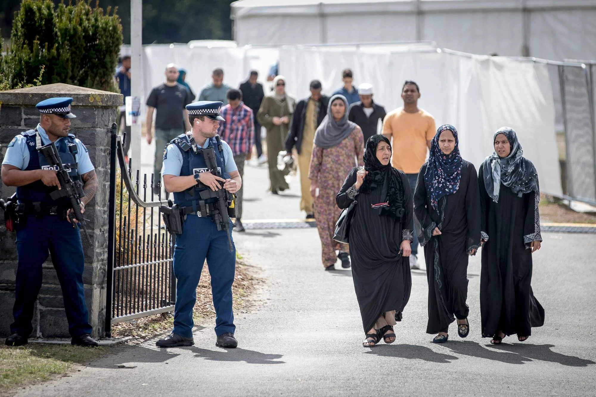 The first funeral for two victims of the Christchurch shooting, Memorial Park Cemetery. Mourners leave the cemetery after burial.
Photograph by Michael Craig.