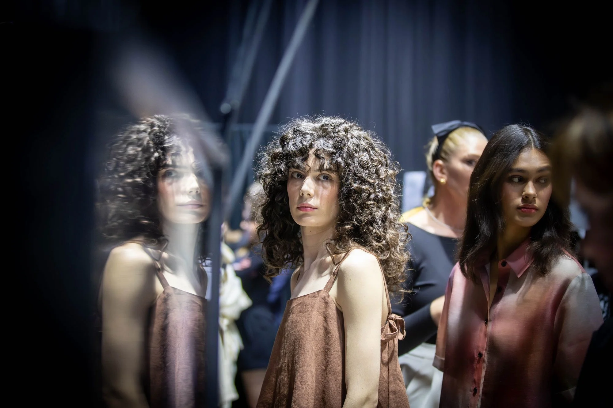 7:38 PM Hope waits for the signal from the runway director to start walking the Juliette Hogan runway show. Hope Phillips walks three runways shows on the first day of Kahuria - New Zealand Fashion Week.