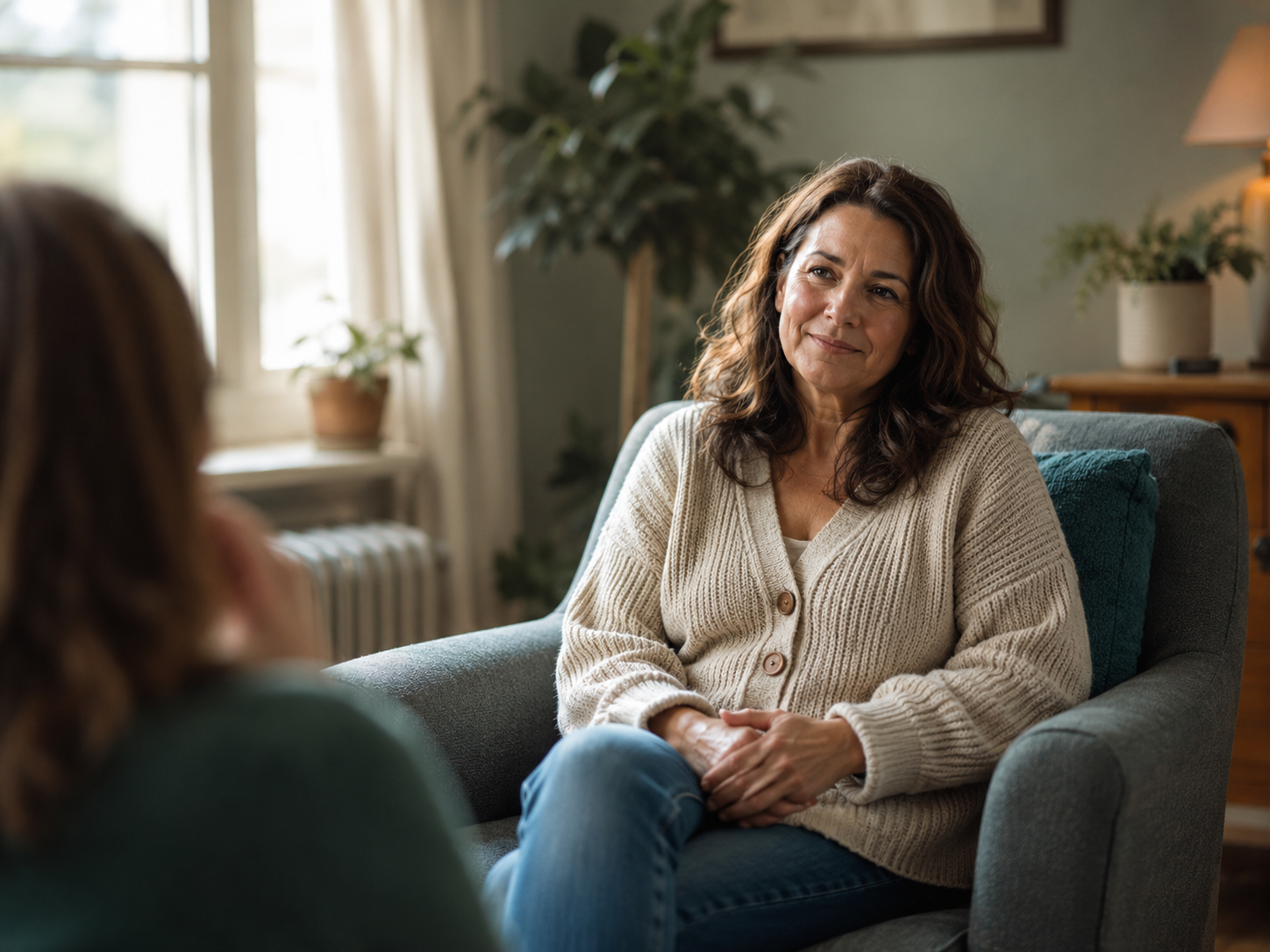 Person seated in warm natural light in a calm office setting, representing whole-person functional and integrative psychiatric care