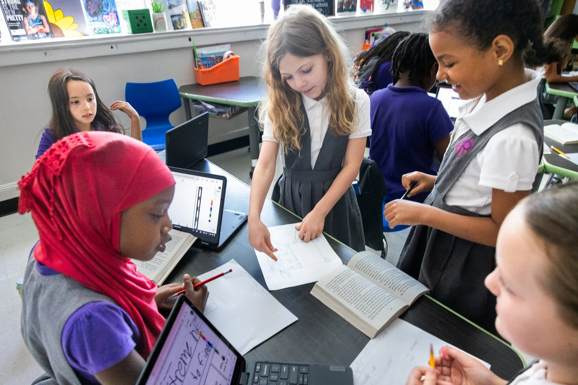 Education photography of students interacting inside Dallas classroom with natural window light
