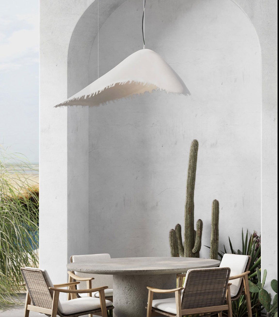 Modern pendant light over outdoor dining area with concrete table and rattan chairs