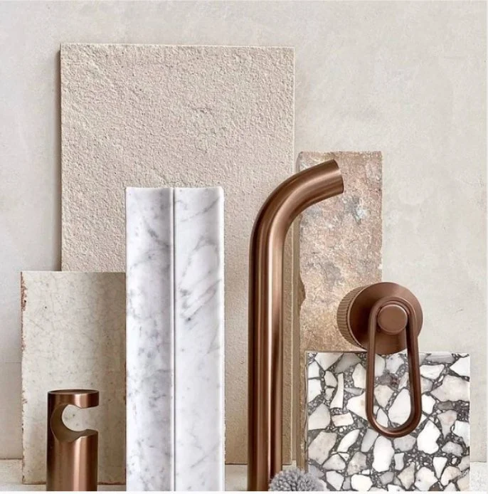 Material and finishes selection board featuring marble, stone and copper fixtures for Melbourne home renovation