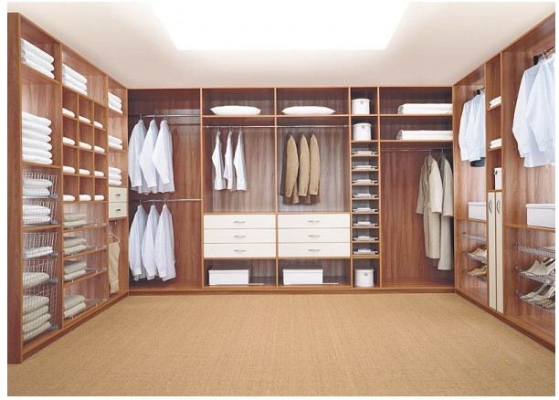 Custom walk-in wardrobe with timber shelving drawers and hanging space