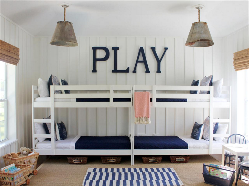 Kids shared bedroom with white bunk beds and navy blue accents