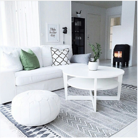 Light and bright Scandinavian style living room with white sofa patterned cushions moroccan pouf and geometric rug home styling on a budget Melbourne