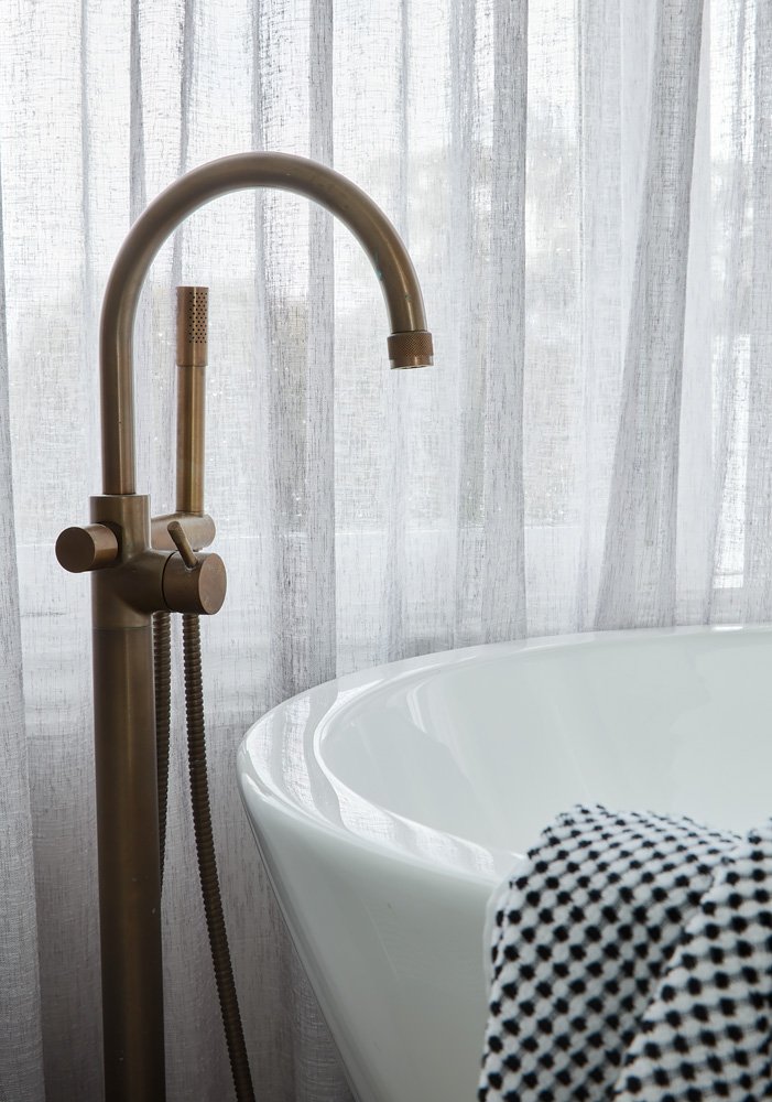 Freestanding white bath with brass floor mounted tapware and sheer linen curtains luxury bathroom design Mount Martha Melbourne