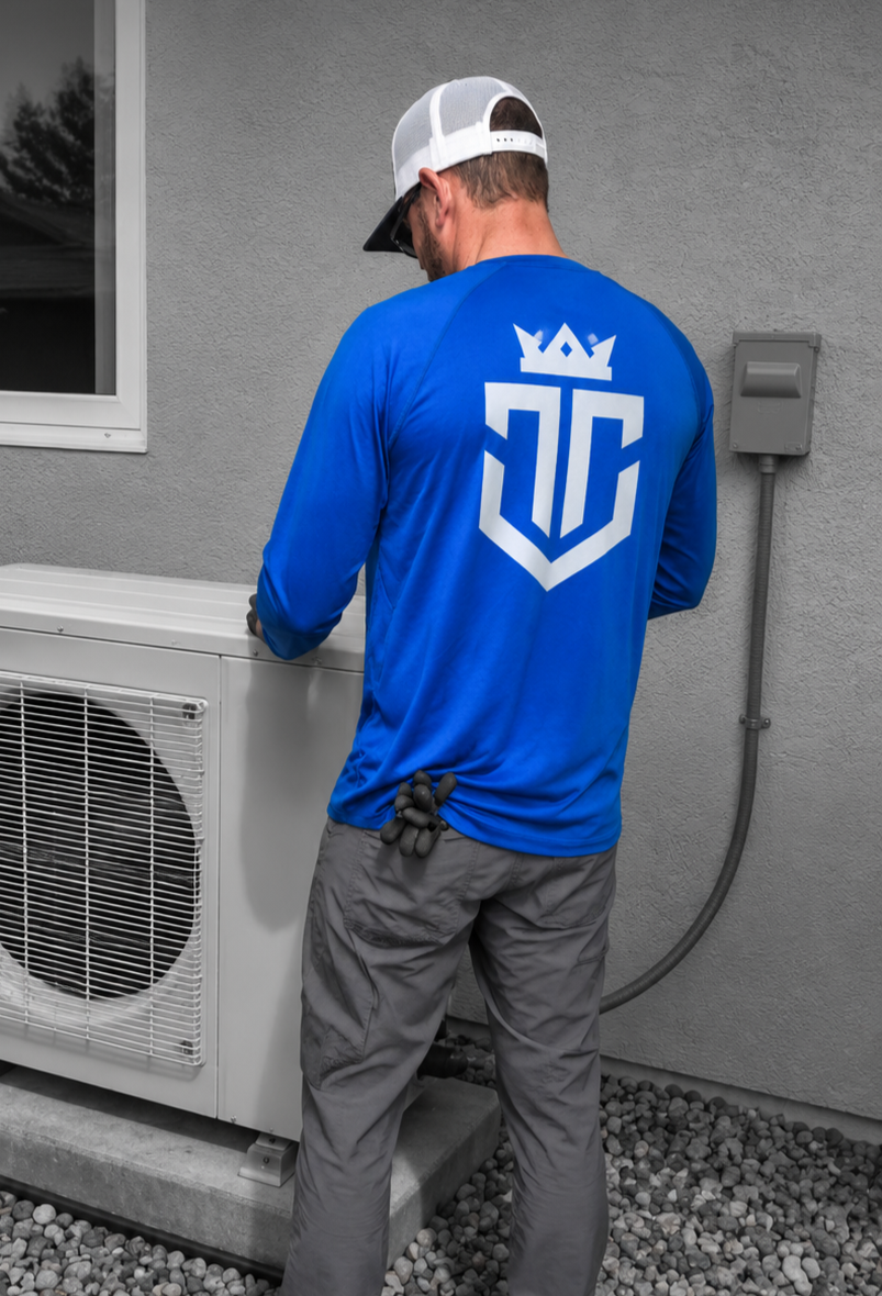 HVAC technician installing residential heat pump and air conditioning system