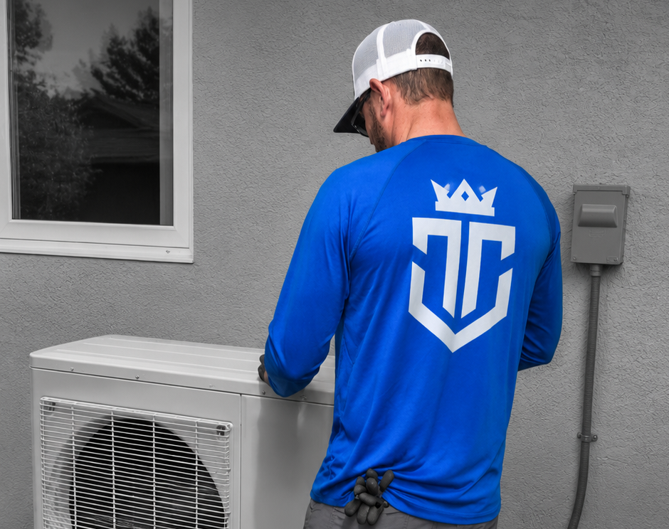 HVAC technician installing energy efficient heating and cooling equipment