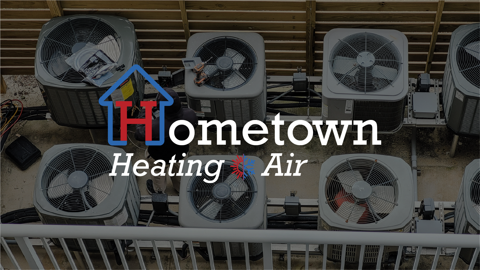 Multiple central air conditioning units installed outdoors on a rooftop or balcony, with overlaid text reading 'Hometown Heating & Air'. Lafollette Jacksboro Caryville Knoxville Tennessee Campbell County Emergency HVAC Services Thermostat New Unit