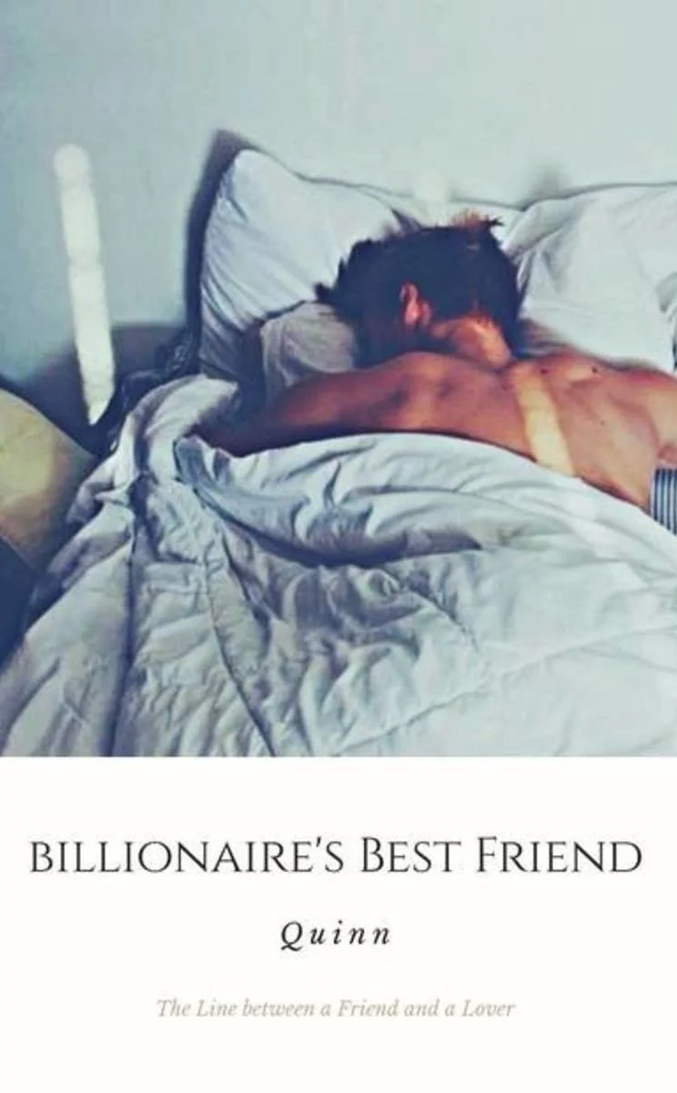 A man with dark hair is lying face down on a bed, partially covered by a beige blanket, with his head turned to the side near a pillow. The bed has white sheets and a headboard against the wall.