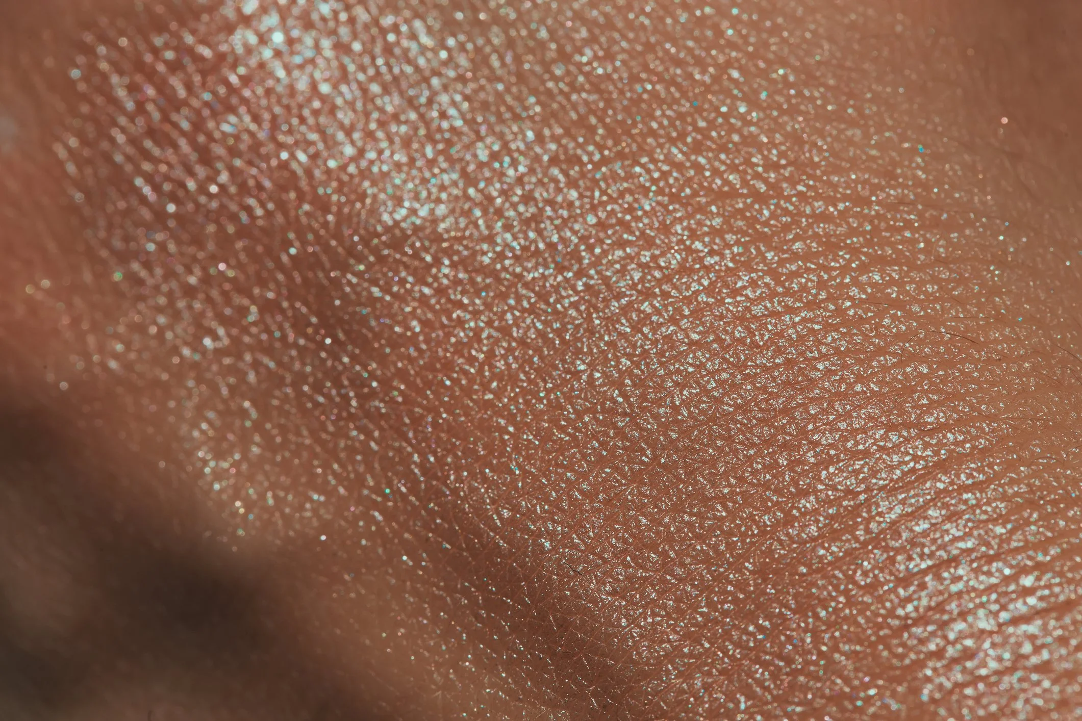 Close-up of human skin with glow from  Nuudiluxe with cell plump technology