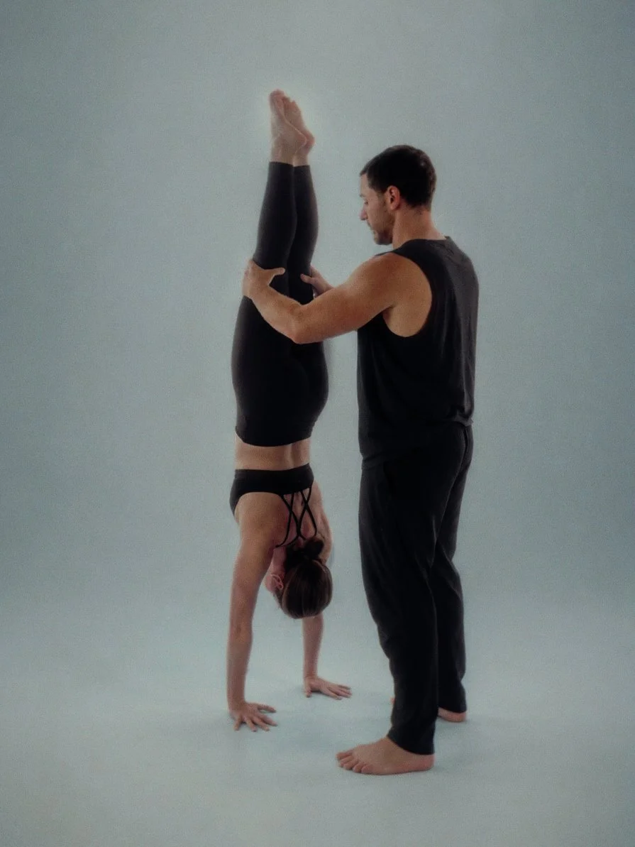 Chris Magee Yoga Teacher Assisting Student in Arm Balance