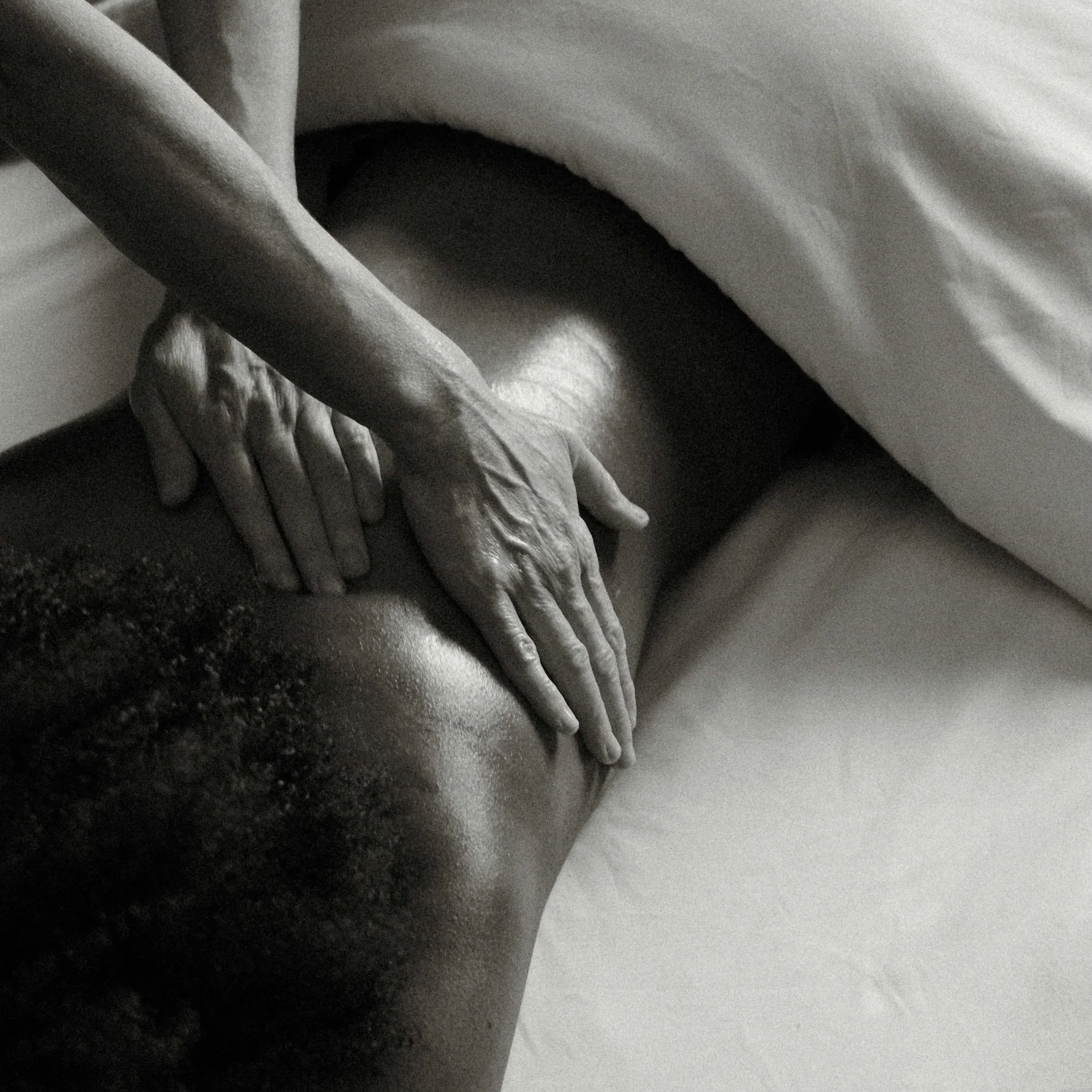 Close-up of a deep tissue therapeutic massage, seen in black and white.