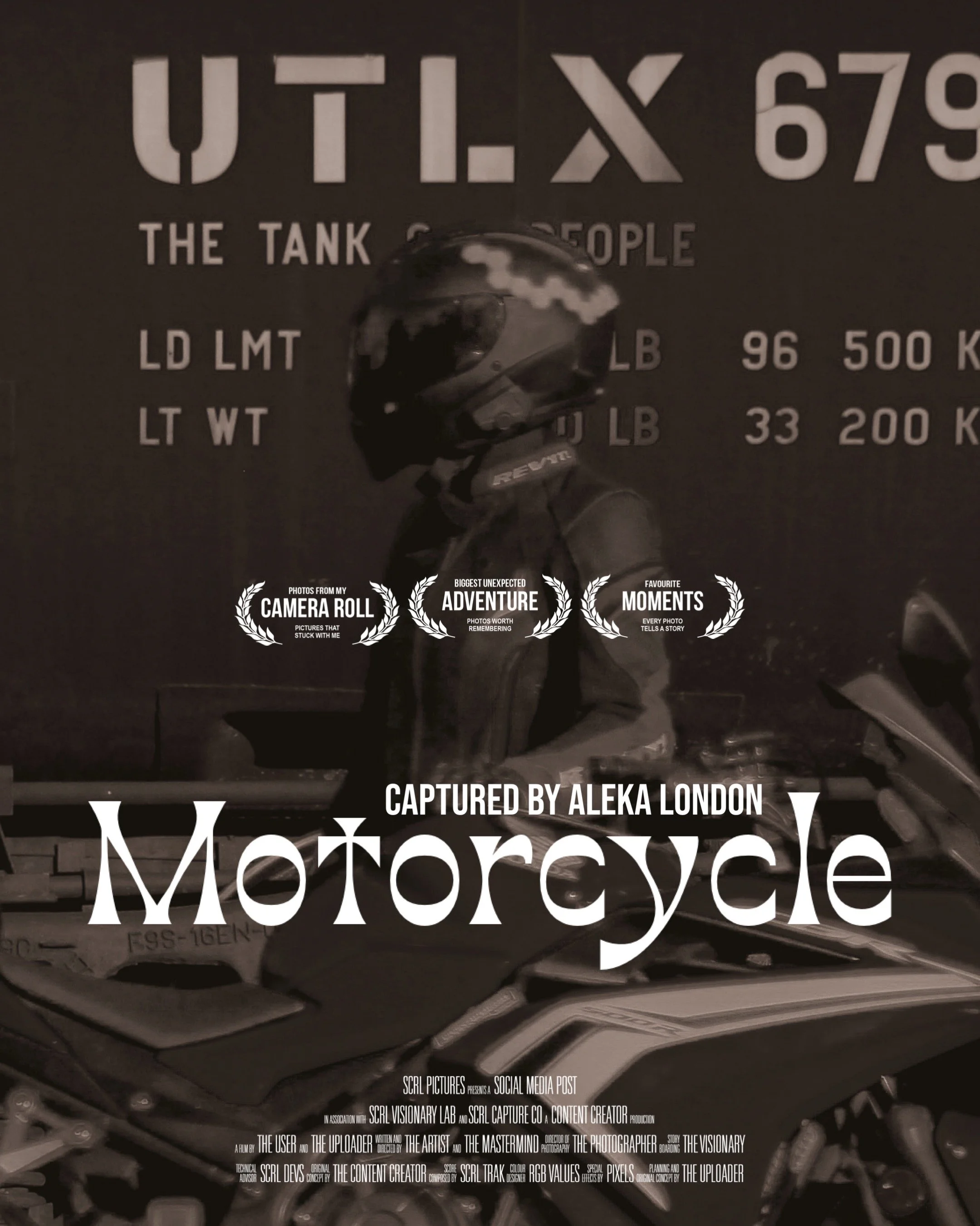 Person in motorcycle helmet and jacket standing next to a motorcycle with a large sign in the background that reads 'UTLX 679' and 'The Tank of the People.'