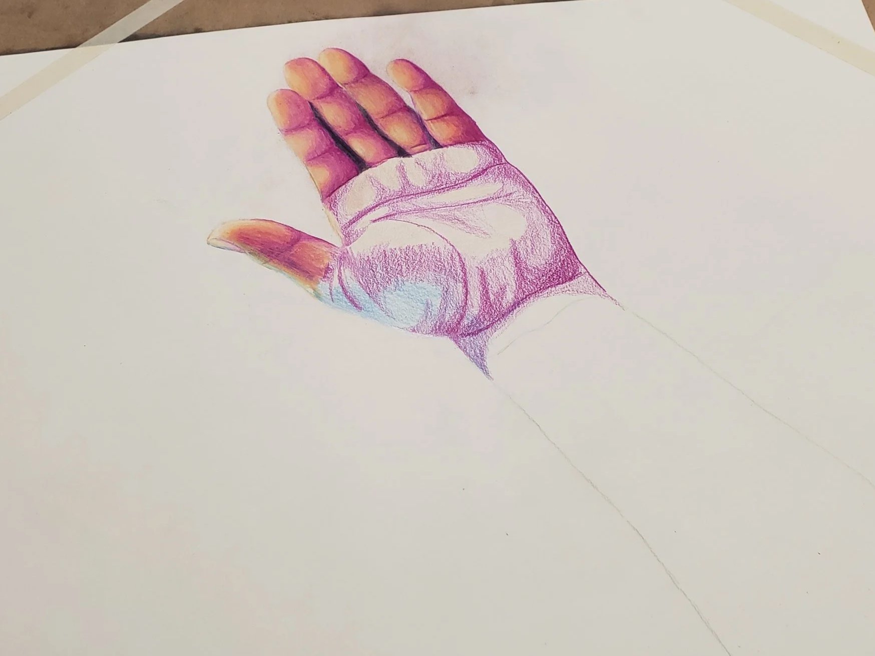 Colorful drawing by Aleka London of a human hand in a relaxed position on a white sheet of paper, with the fingers lightly curled and the thumb extended downward, showing detailed shading and coloring.