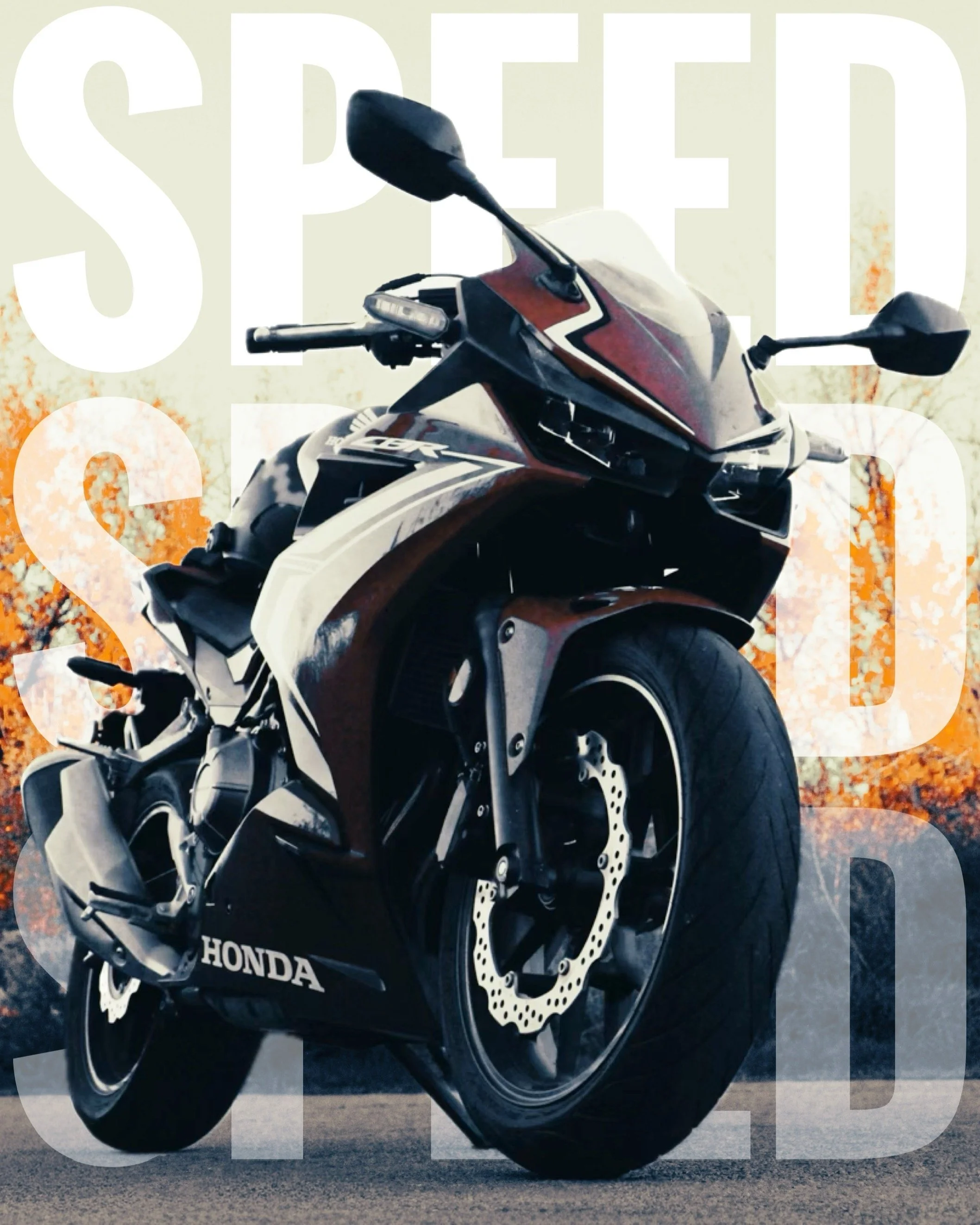 Red, white, and black Honda CBR sport motorcycle parked on pavement with sunset or autumn trees in background.