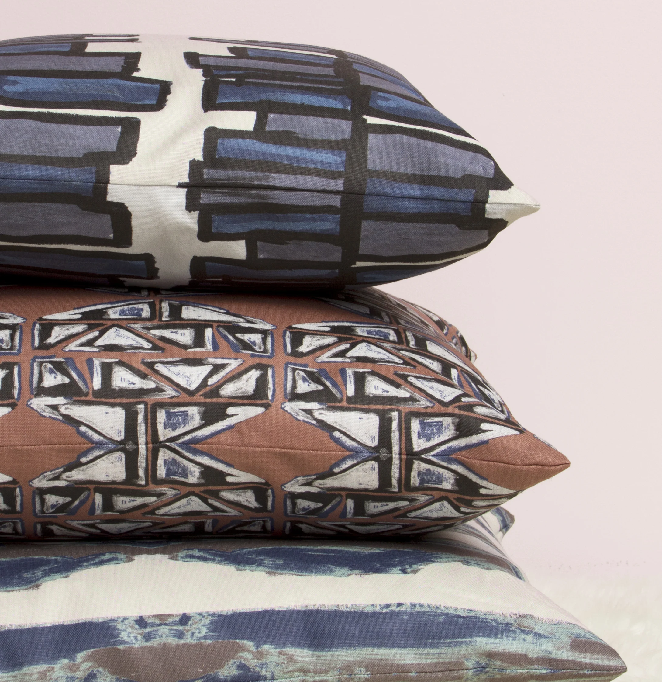 stack of pillows - against pink wall.jpg