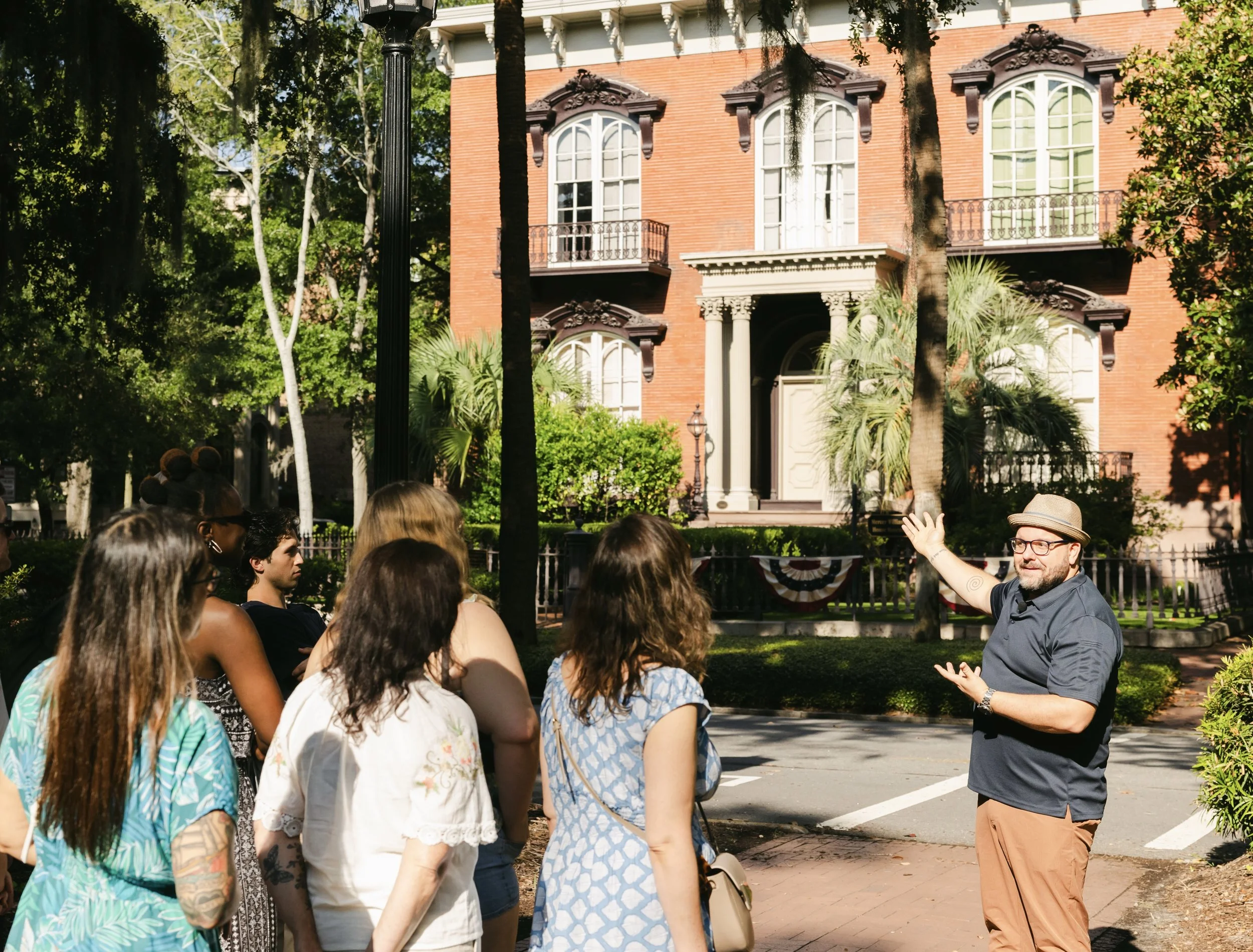 A Savannah Untold tour group in Monterey Square, near the monument to Casimir Pulaski