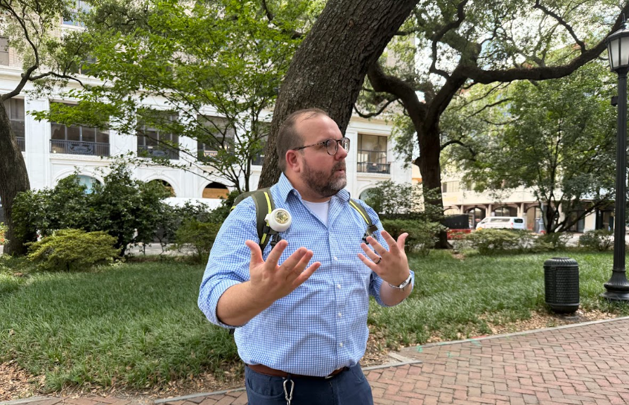 A photo of Malcolm, the tour guide, telling stories to guests on a tour in a Savannah square