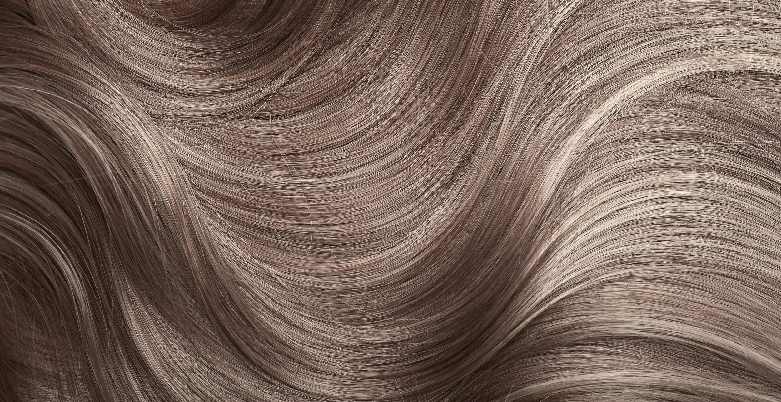 Close-up of wavy, multi-toned blonde hair.