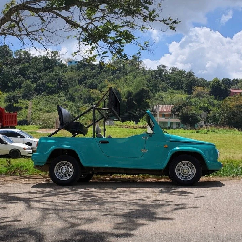 This majestic teal cruiser is used for government events and parades. The seat has been raised for better visibility of occupants and metal framework has been added to house speakers during events. 