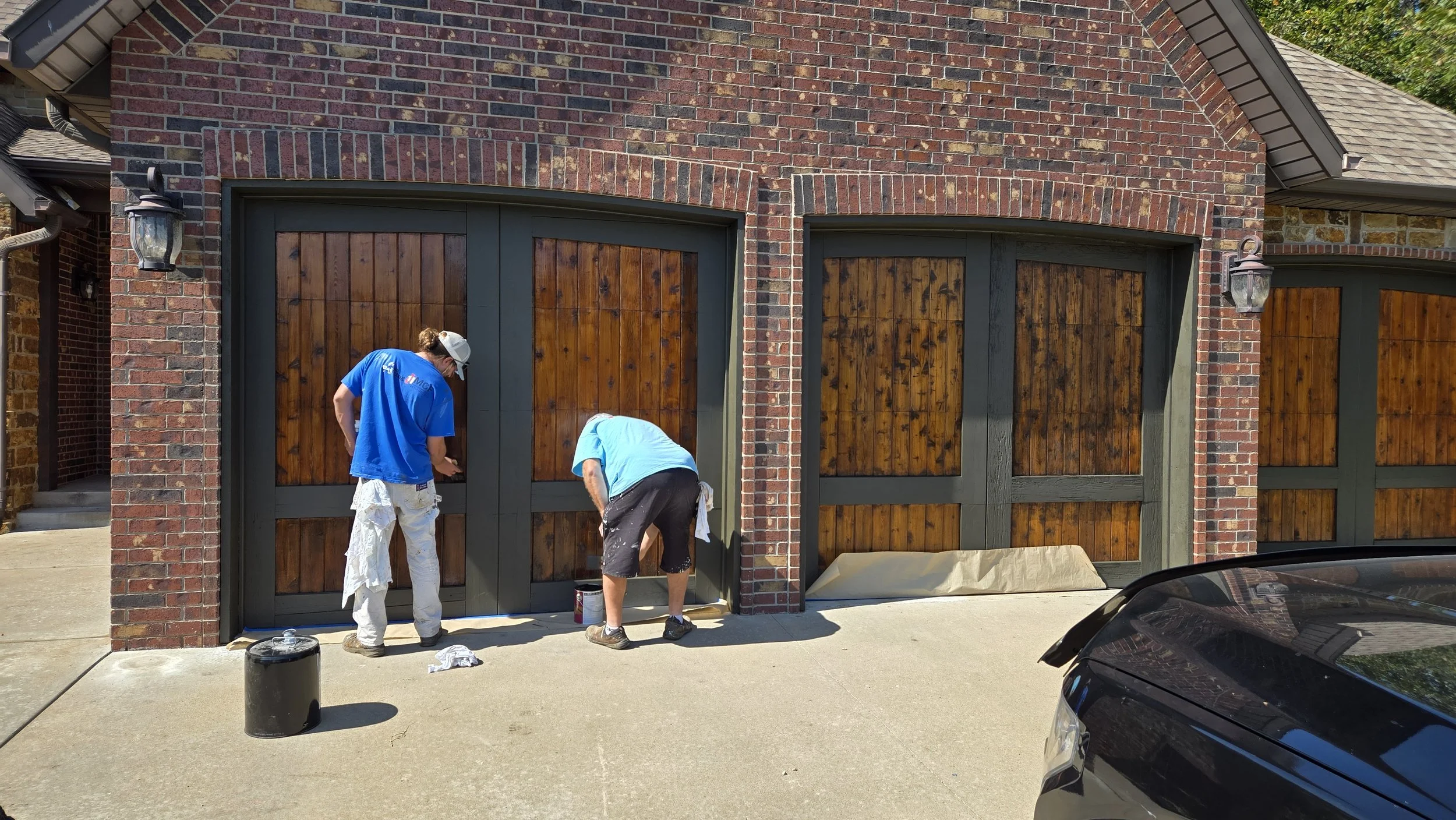 Refinishing wood garage doors with stain and sealer in Joplin, Mo.