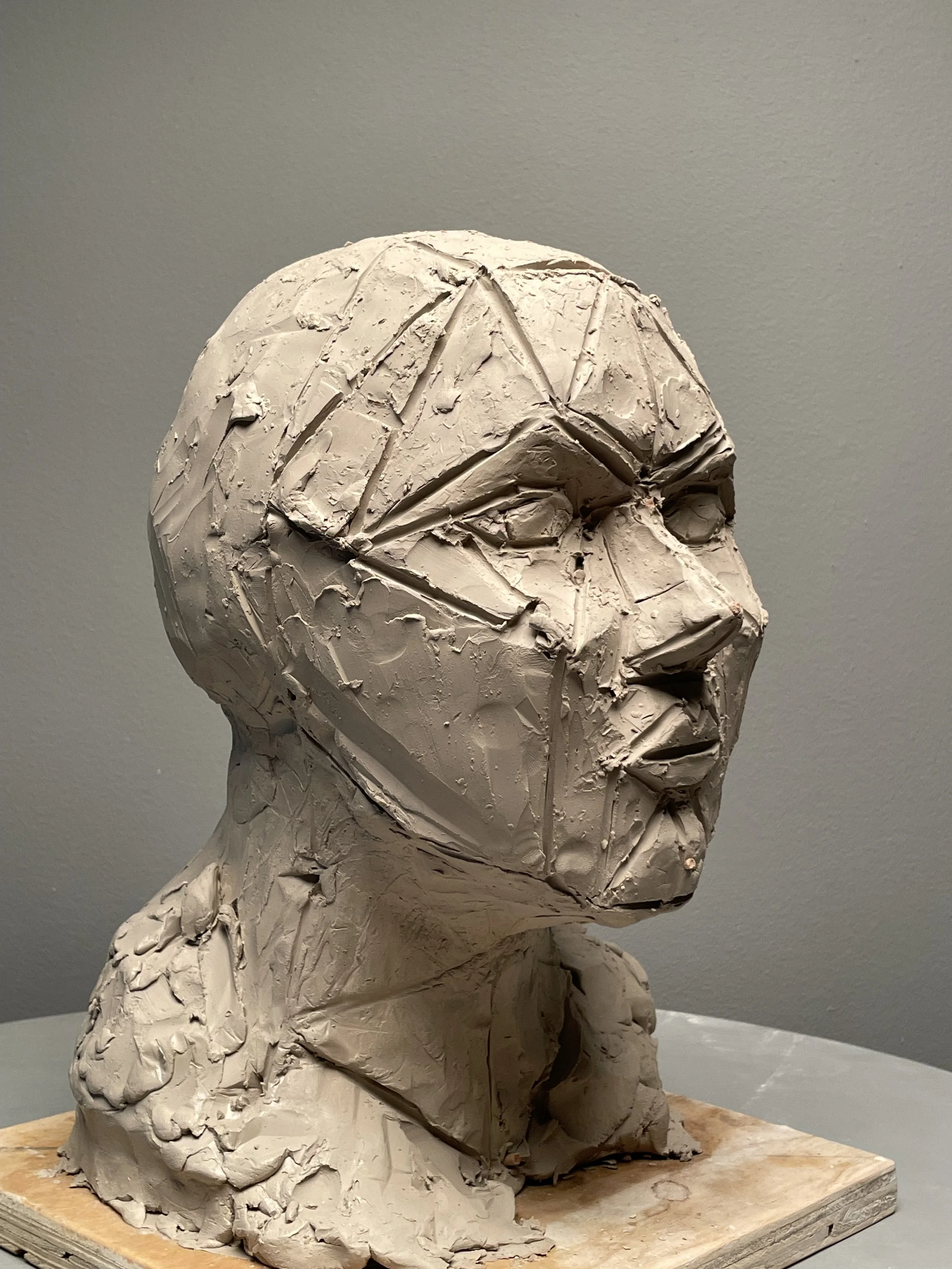 Self-portrait in clay, geometrically abstracted. 2024.