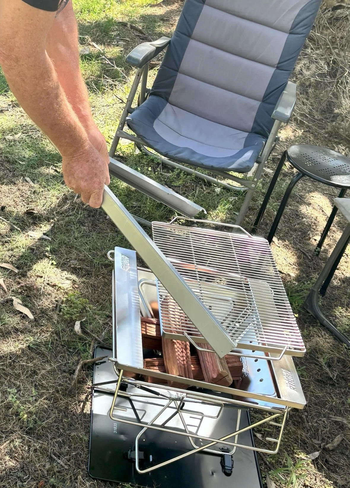 Fire Pit Tongs lifting grill off of fire pit, fire tongs doing their thing