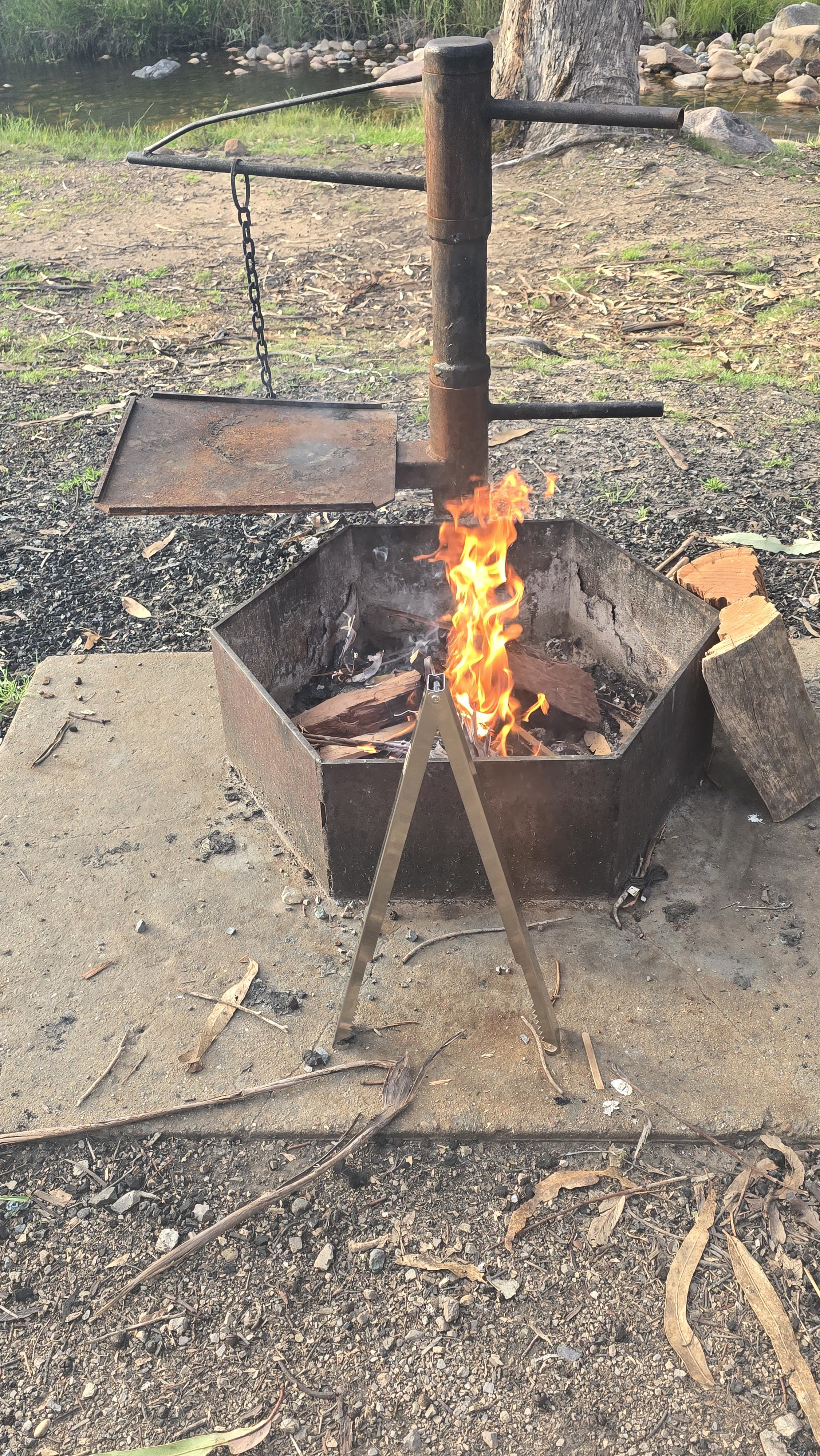 Two Tossers who have a set of Tongs for Tossers to work on the campfire