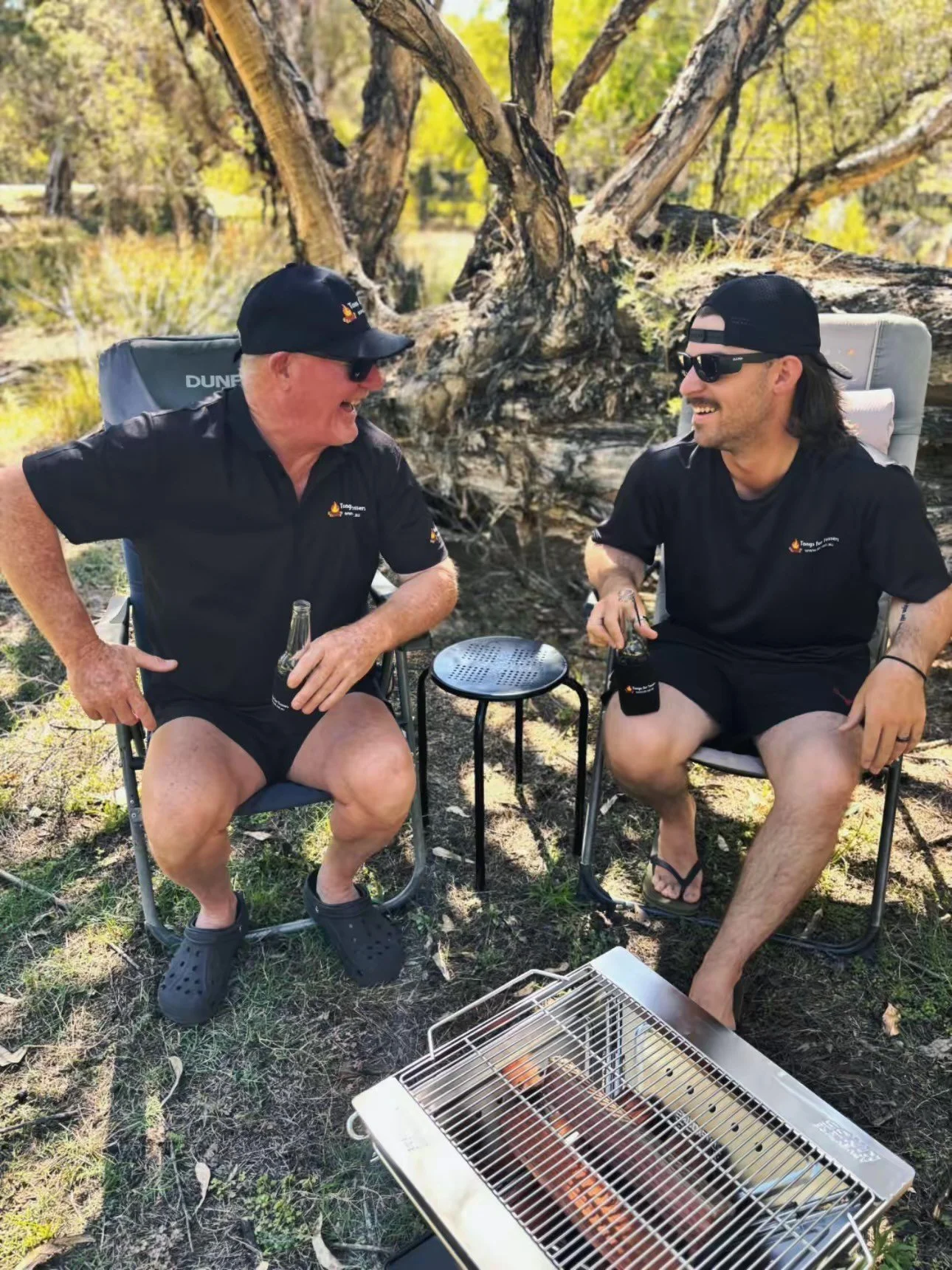 Two Tossers who have a set of Tongs for Tossers to work on the campfire