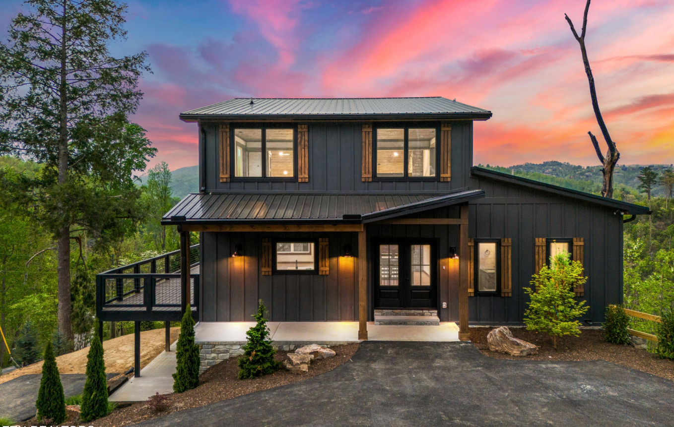 Modern mountain home exterior design in the Smoky Mountains showcasing warm contemporary architecture and elevated property styling by GSM Agency.