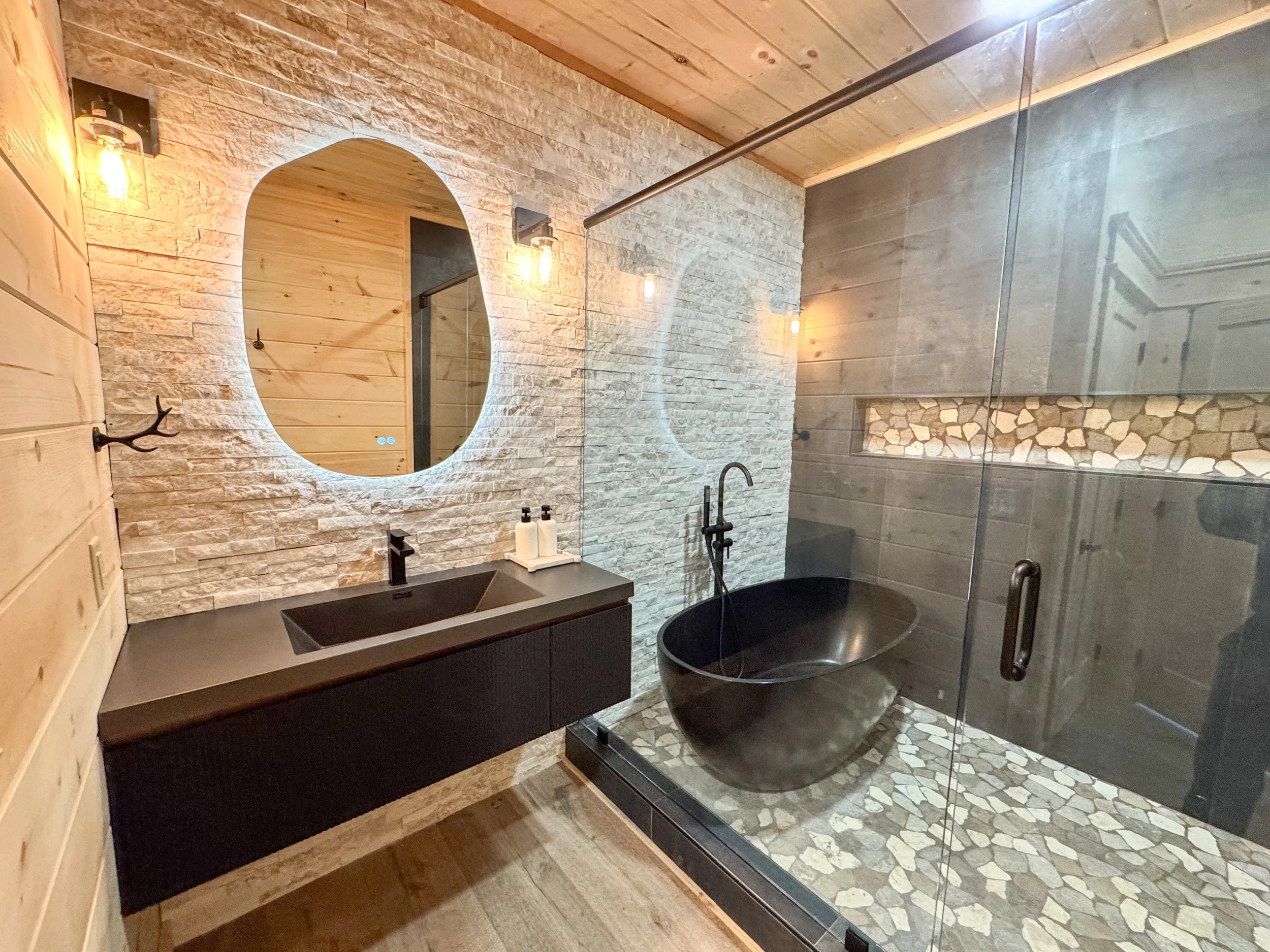 Modern bathroom with stone and tile finishes in a Smoky Mountain cabin
