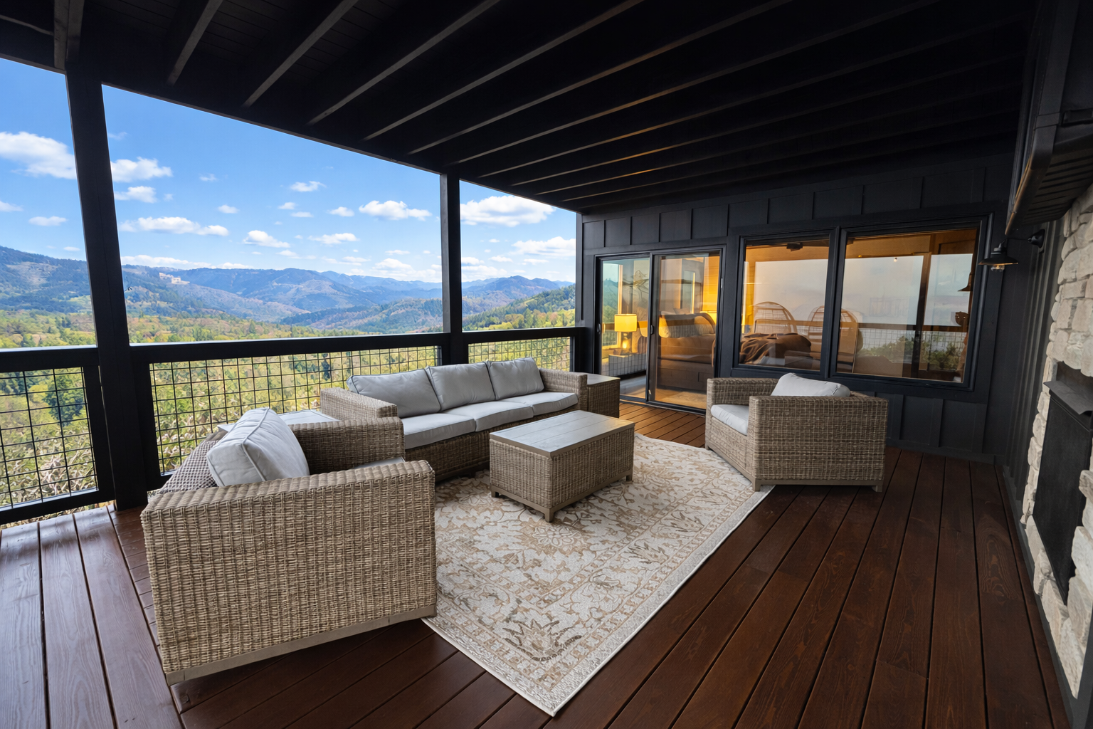 Covered outdoor deck with seating and sweeping Smoky Mountain views in a Gatlinburg, TN cabin retreat.