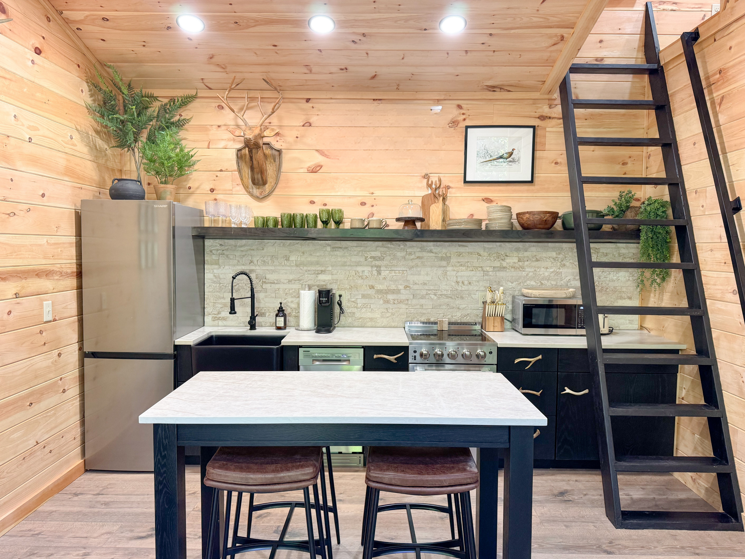 Full-service interior design for a modern rustic Smoky Mountain home featuring custom cabinetry, wood-paneled walls, and luxury kitchen styling by GSM Agency.