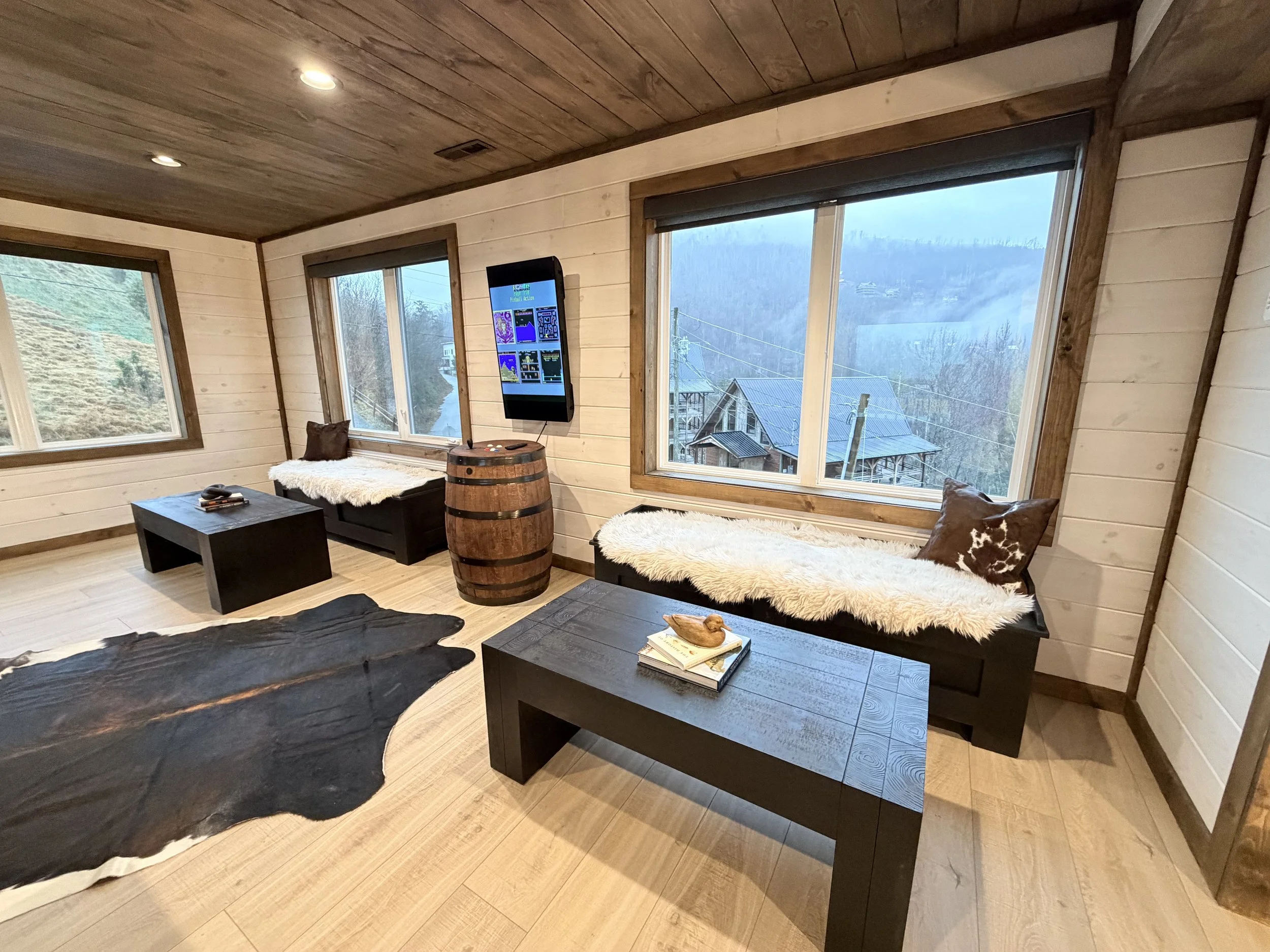Cabin game and lounge area with large windows and mountain views in Gatlinburg, TN.