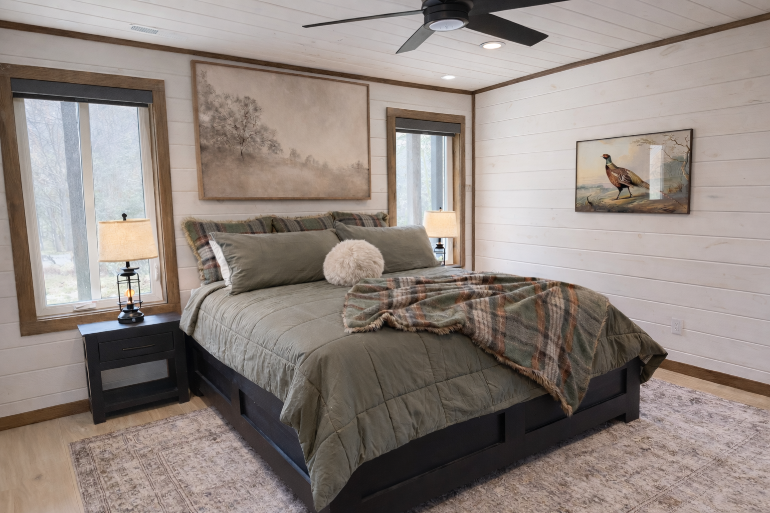 Secondary bedroom in a Gatlinburg mountain cabin with soft textiles, natural light, and wood-accented walls.