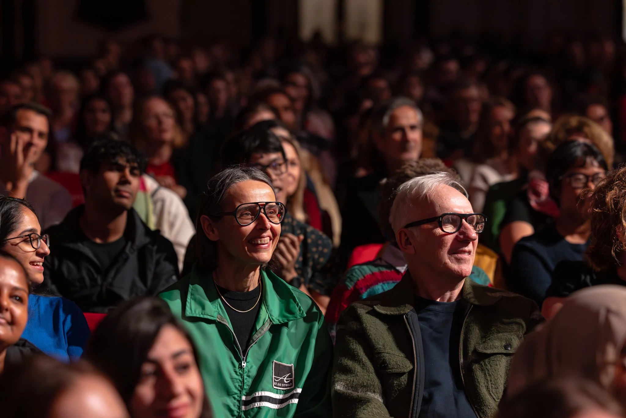 Audience members enjoying a poetry slam.