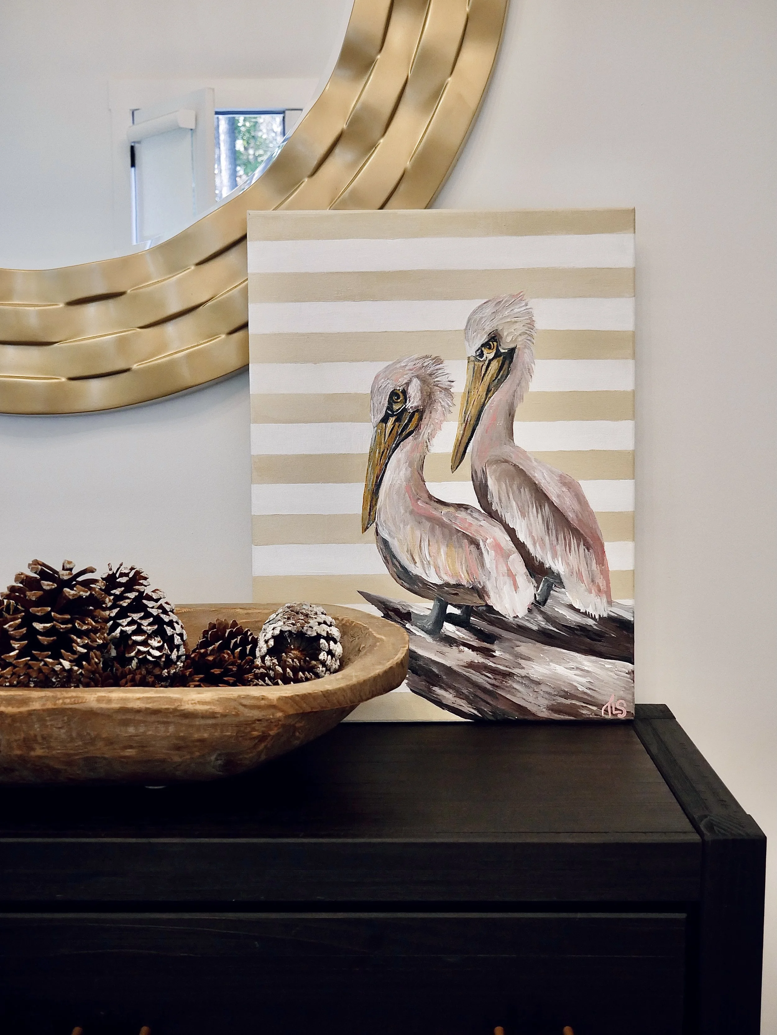 Painting of two pelicans on a wooden branch, with beige and white stripes in the background.
