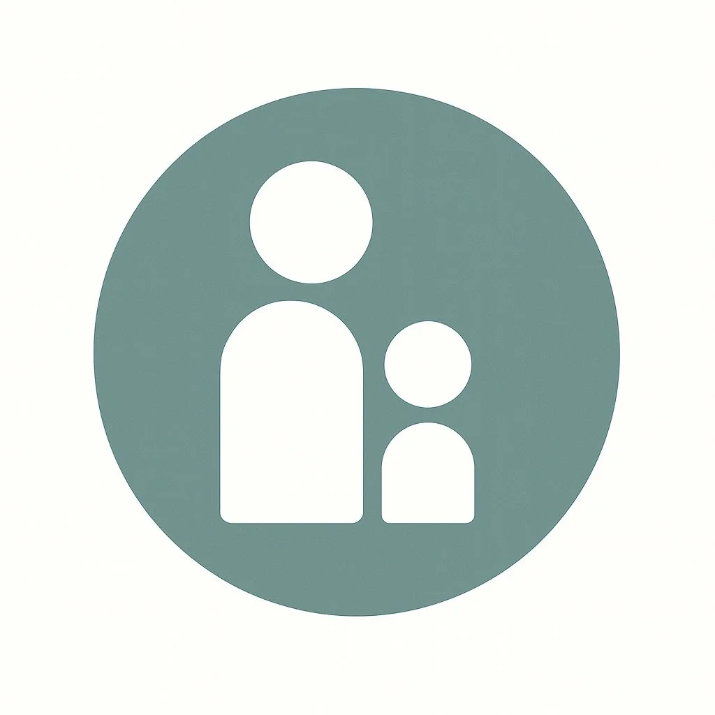 A woman with shoulder-length black hair smiling in front of green plants in a bright indoor setting.