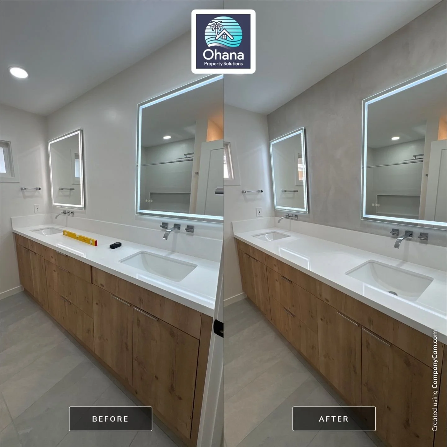 Side-by-side comparison of a bathroom before and after renovation. The bathroom features a large mirror with LED lighting, a white countertop with a built-in sink, and wooden cabinets. The 'after' image shows the microcement accent wall.