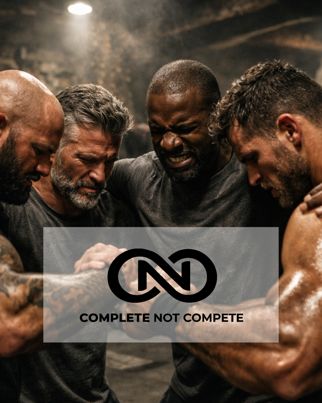 A group of five men with muscular builds engaged in a tense arm wrestling match, showing intense emotion, in a gritty gym or training space.
