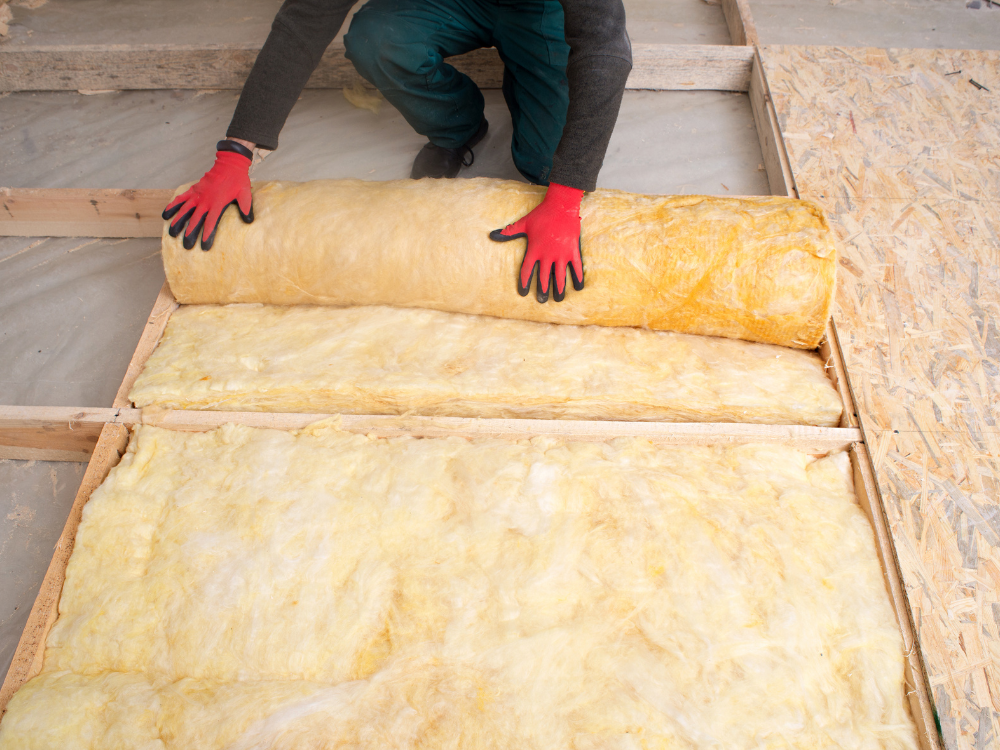 A person installing insulation