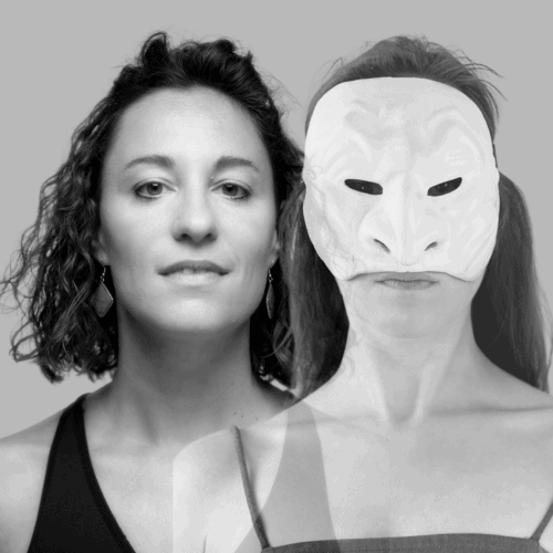 Two women, one with curly hair and another wearing a white mask with black eyes.