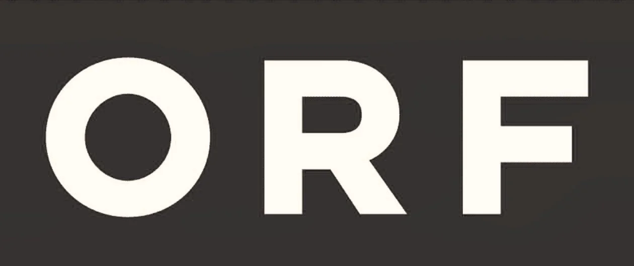 Close-up of the word 'ORE' in large white letters on a dark background.