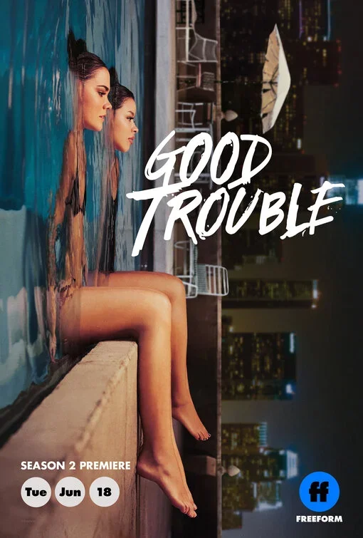Two women with long hair sit side by side in a swimming pool at night, with city lights in the background. The text 'Good Trouble' is overlaid on the image, along with details about the season 2 premiere occurring on Tuesday, June 18, and the Freefor