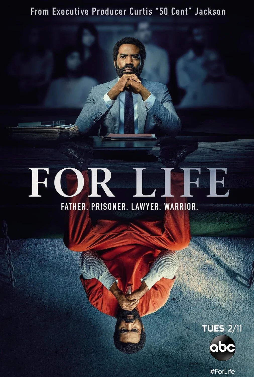 A promotional poster for the TV show 'For Life' featuring a man dressed as a lawyer sitting at a desk, with his reflection in the water below. The reflection shows him in an orange prison jumpsuit with hands clasped, and the background is dark with b
