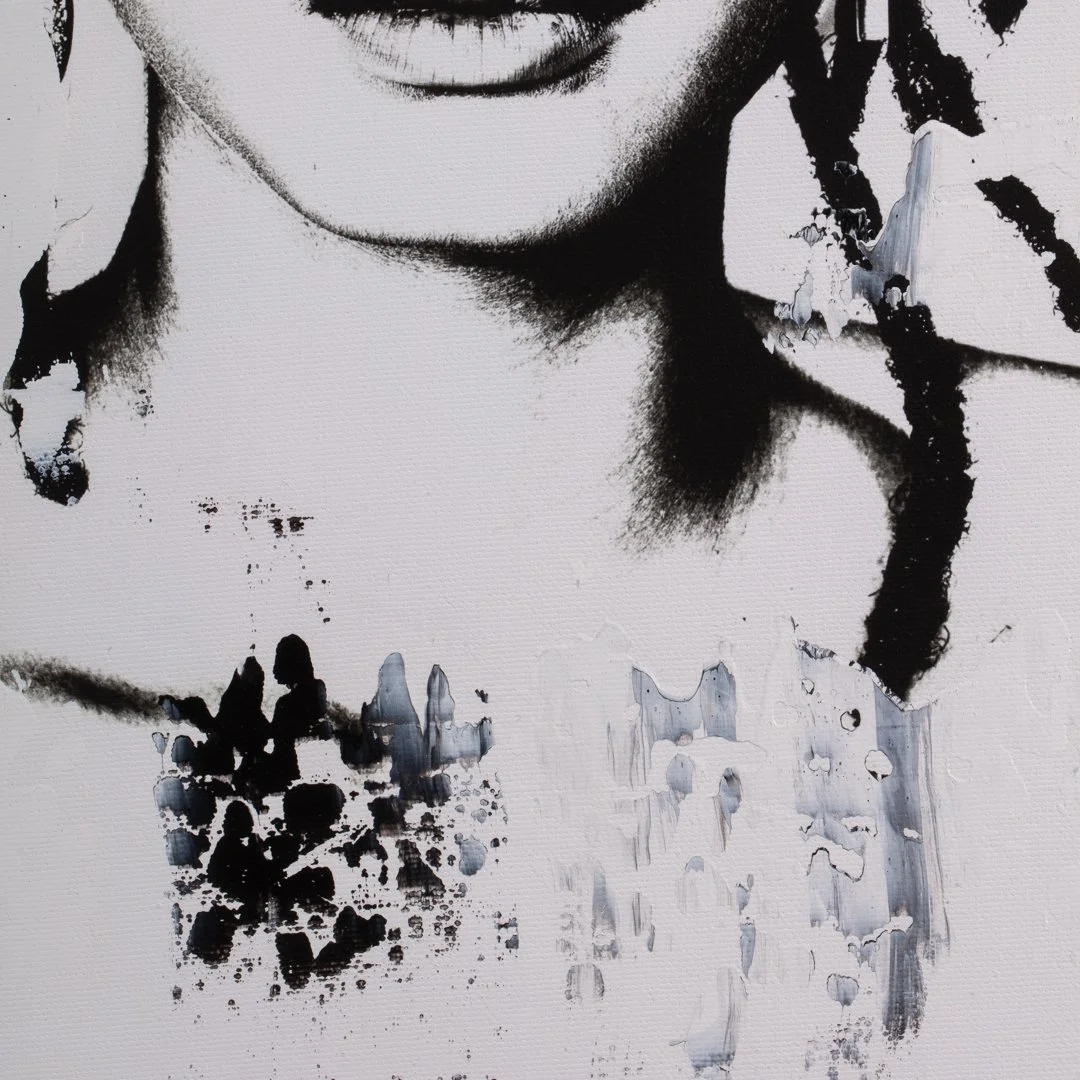 Close-up of a black-and-white street art portrait showing part of a person's face, neck, and abstract dripping paint details.